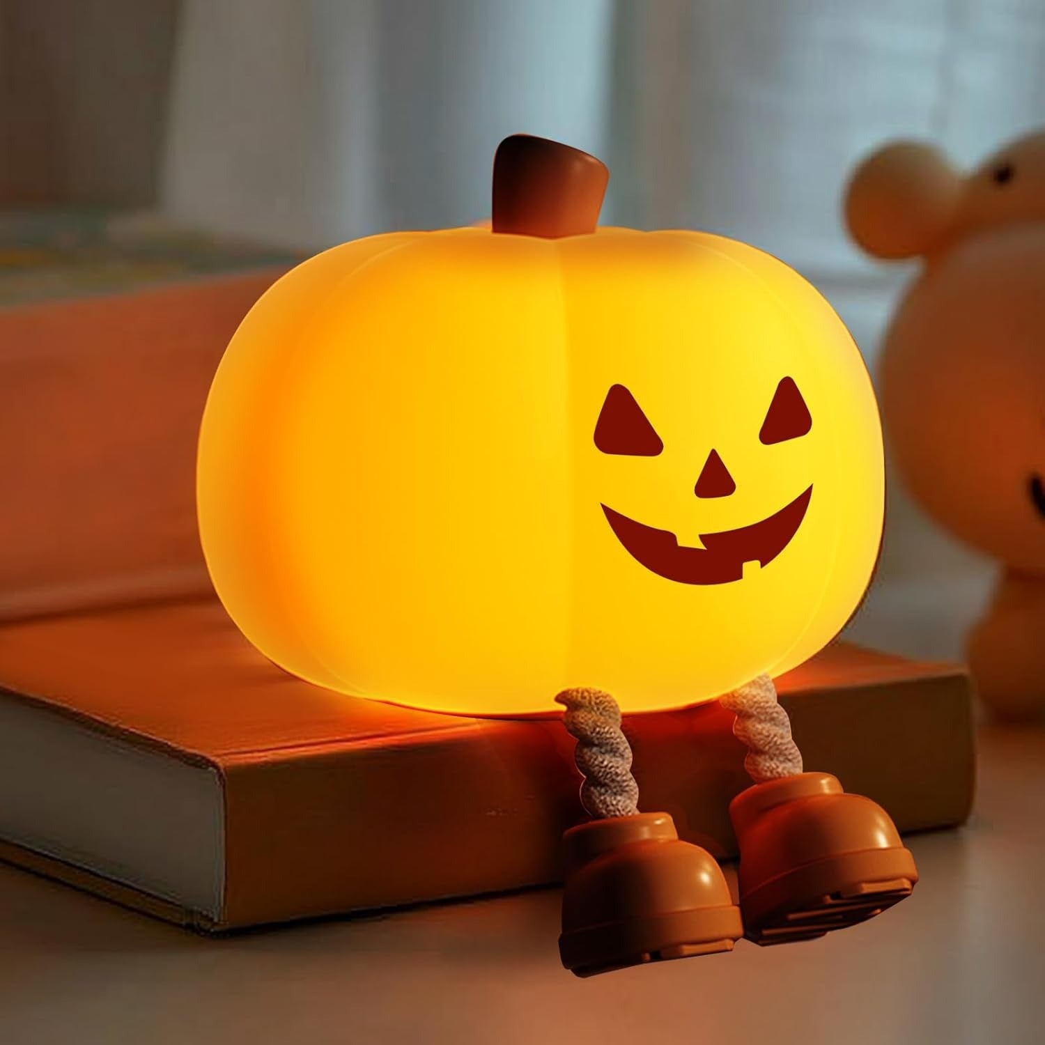 Pumpkin-shaped night light with a smiling face